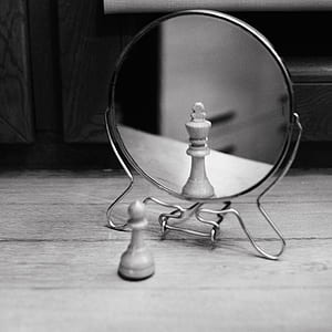 Grayscale Photo of Reversible Mirror in Front of Chess Piece thumbnail