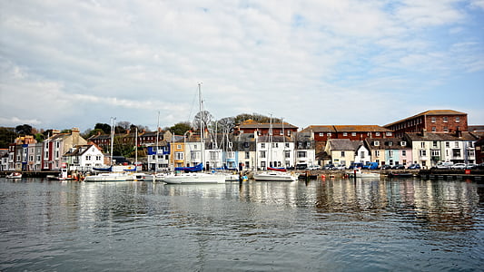 boats on body of water near buildings thumbnail