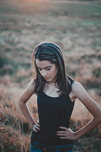 woman standing on brown grasses thumbnail