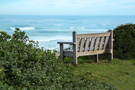 brown wooden futon near sea at daytime thumbnail