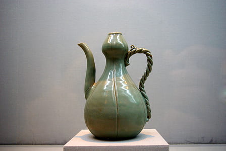 green ceramic pitcher on white surface thumbnail