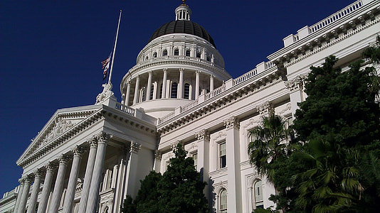 white concrete building under clear blue sky during daytime thumbnail