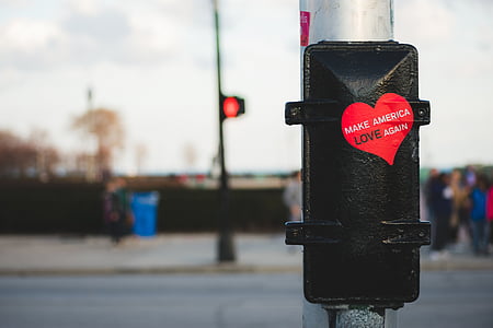 close-up photo of Make America love again text on black metal post thumbnail