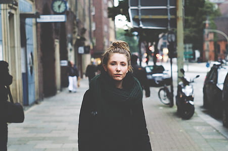 woman standing on street near road thumbnail