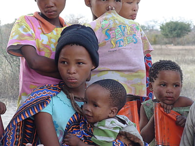 photo of woman with children near green trees thumbnail