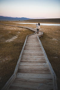 woman carrying child on dock thumbnail