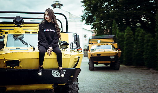 woman sitting on yellow vehicle thumbnail
