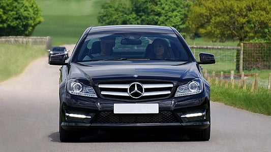 man and woman in black Mercedes-Benz c-class thumbnail