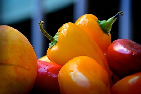 selective focus photography of yellow and red capsicums thumbnail