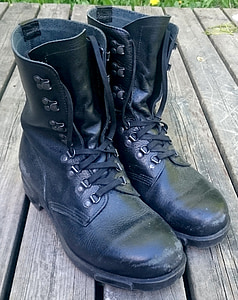 pair of black leather work boots on brown surface thumbnail