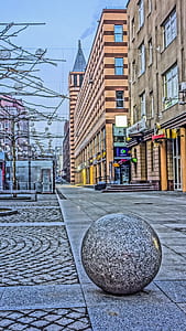round stone near buildings at daytime thumbnail
