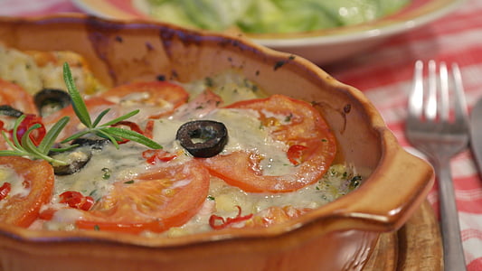 selective focus photography of tomato dish in bowl beside stainless steel fork thumbnail