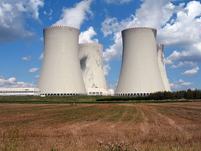 white power plant surrounded by green field thumbnail