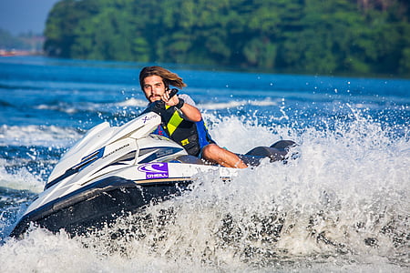 man riding watercraft near island during day thumbnail