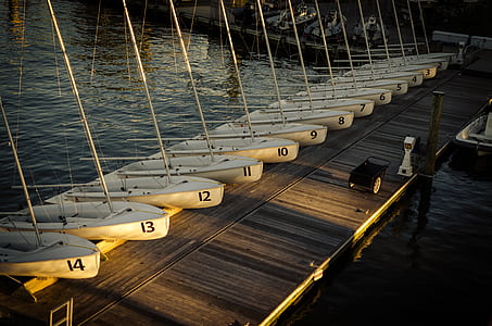 white boats on brown boardwalk thumbnail