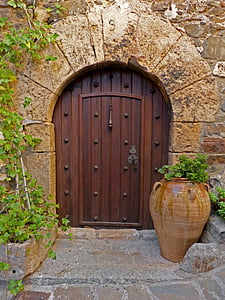 brown wooden door beside round brown pot plant thumbnail