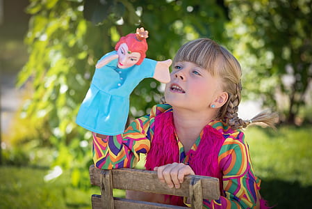girl wearing multicolored top during daytime thumbnail