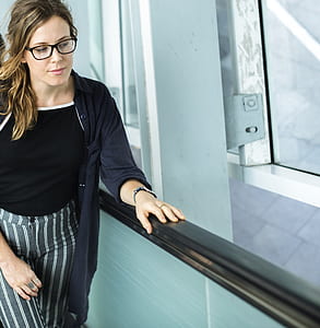 woman wearing black halter-neckline top and black cardigan thumbnail