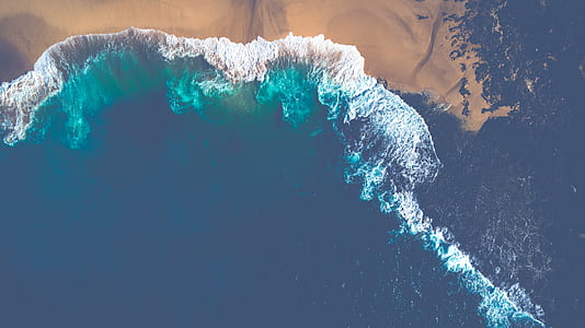 aerial photo of sea waves splashing through shore thumbnail
