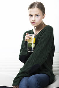 girl holding glass on bed thumbnail