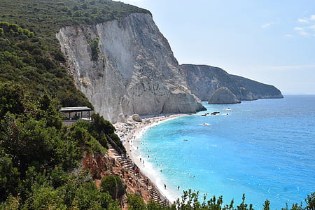 white building near cliff thumbnail