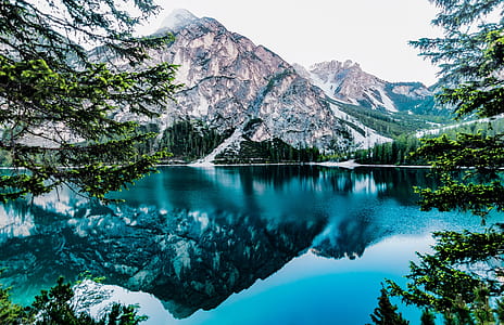 mountain alps near body of water graphic wallpaper thumbnail