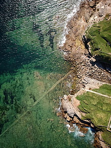 aerial photography of mountain near body of water thumbnail
