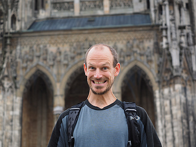 man standing in front of brown building thumbnail