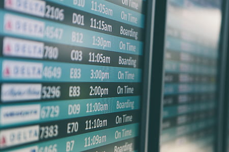 selective focus photography of plane flight schedule board thumbnail