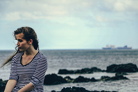 selective focus of woman sitting on coast way thumbnail