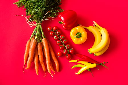Fresh Fruits and Vegetables on Red Background Still Life thumbnail