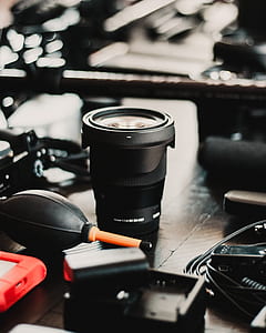 black DSLR camera lens on black surface thumbnail