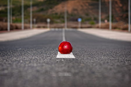 selective focus of red apple on road thumbnail