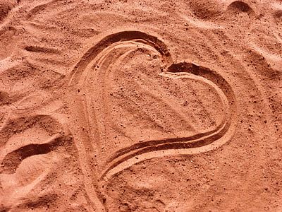 heart drawing on brown sand thumbnail