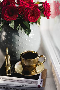Gold cup of coffee and red roses bouqet thumbnail
