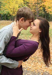 shallow focus photography of man hugging woman thumbnail