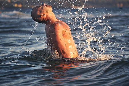 man in body of water photo thumbnail