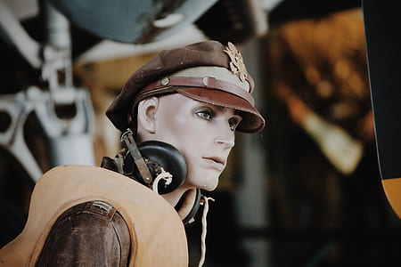 mannequin wearing aviation headset and brown peaked cap and vest thumbnail