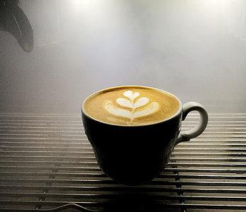latte art in black teacup thumbnail