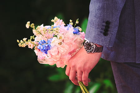 man holding pink and blue flower bouquet thumbnail