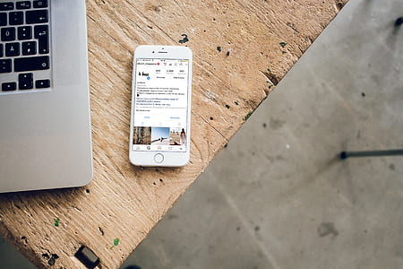 turned on silver iPhone 6 near MacBook thumbnail