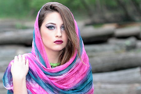 woman wearing teal and pink scarf in tilt shift lens photo thumbnail