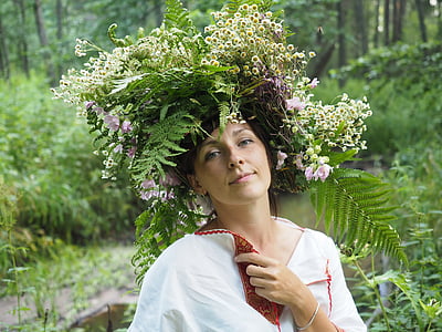 selective focus photography of woman wearing leaves and flowers hat thumbnail