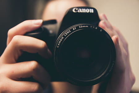 person taking a photo using Canon DSLR camera thumbnail