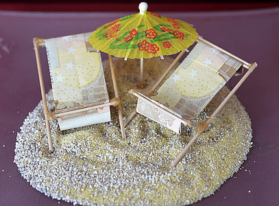two sun loungers beside paper umbrella on sand miniatures thumbnail
