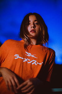 woman wearing orange Reebook shirt thumbnail