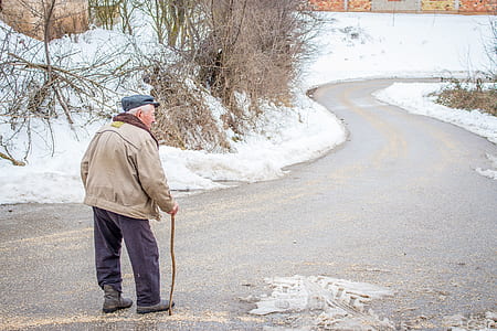 man in brown jacket in walking gesture during winter season thumbnail