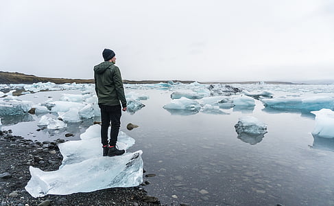 man standing on ice under white sky thumbnail