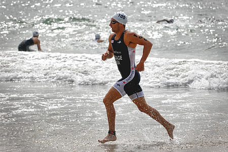 man run near seashore during daytime thumbnail