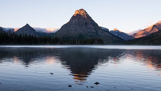 landscape photography of mountains and body of water thumbnail